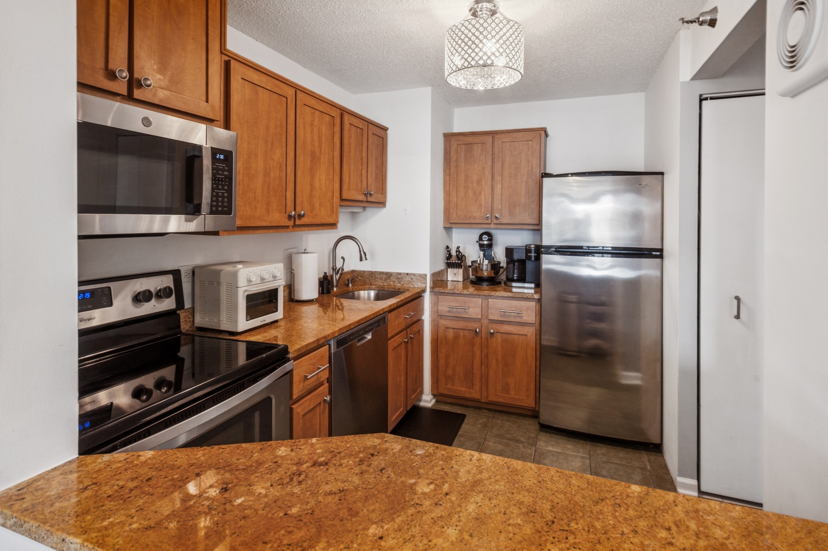 111 West Maple Street, Unit 1704 Chicago, IL 60610 - Photo 8 of 24 a kitchen with a refrigerator stove and microwave