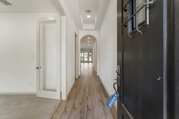 a view of hallway with wooden floor