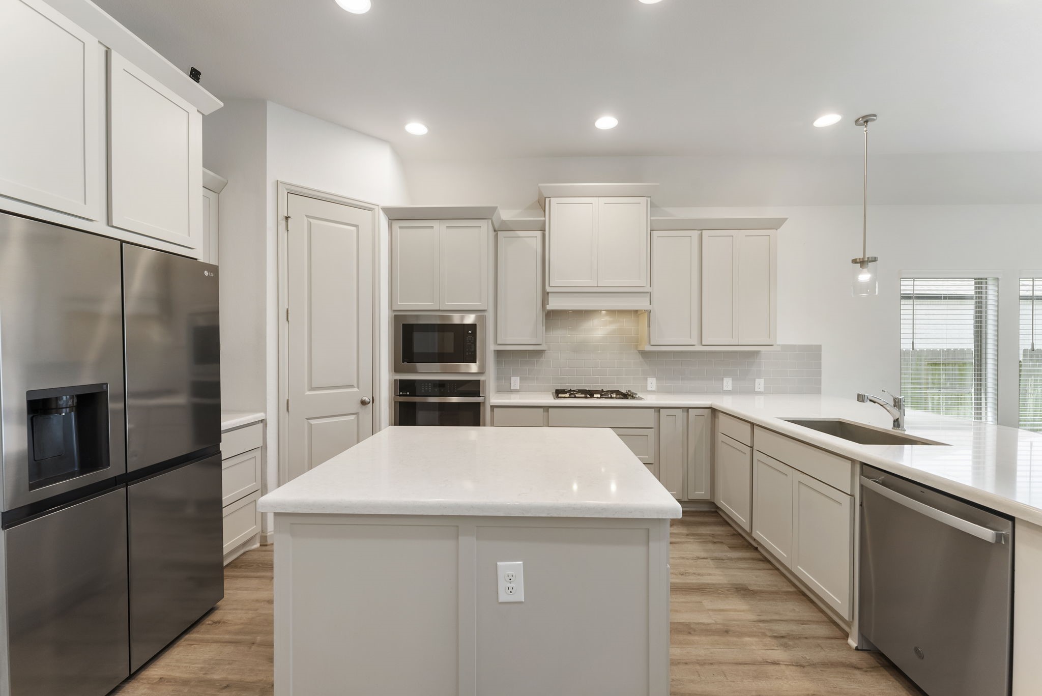 17192 Wild Robin Lane Conroe, TX 77302 - Photo 3 of 15 a kitchen with stainless steel appliances a sink stove refrigerator and cabinets