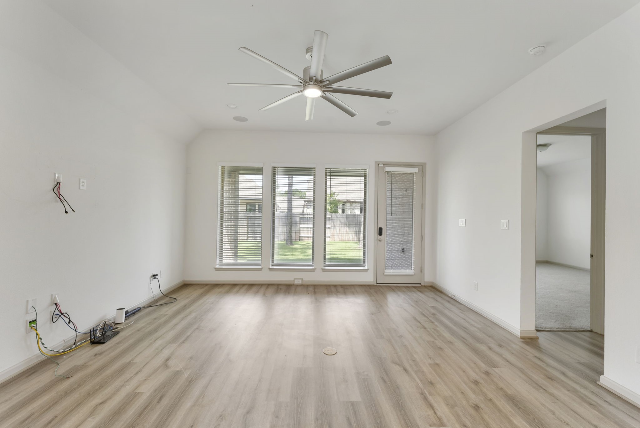 17192 Wild Robin Lane Conroe, TX 77302 - Photo 6 of 15 a view of empty room with wooden floor and fan