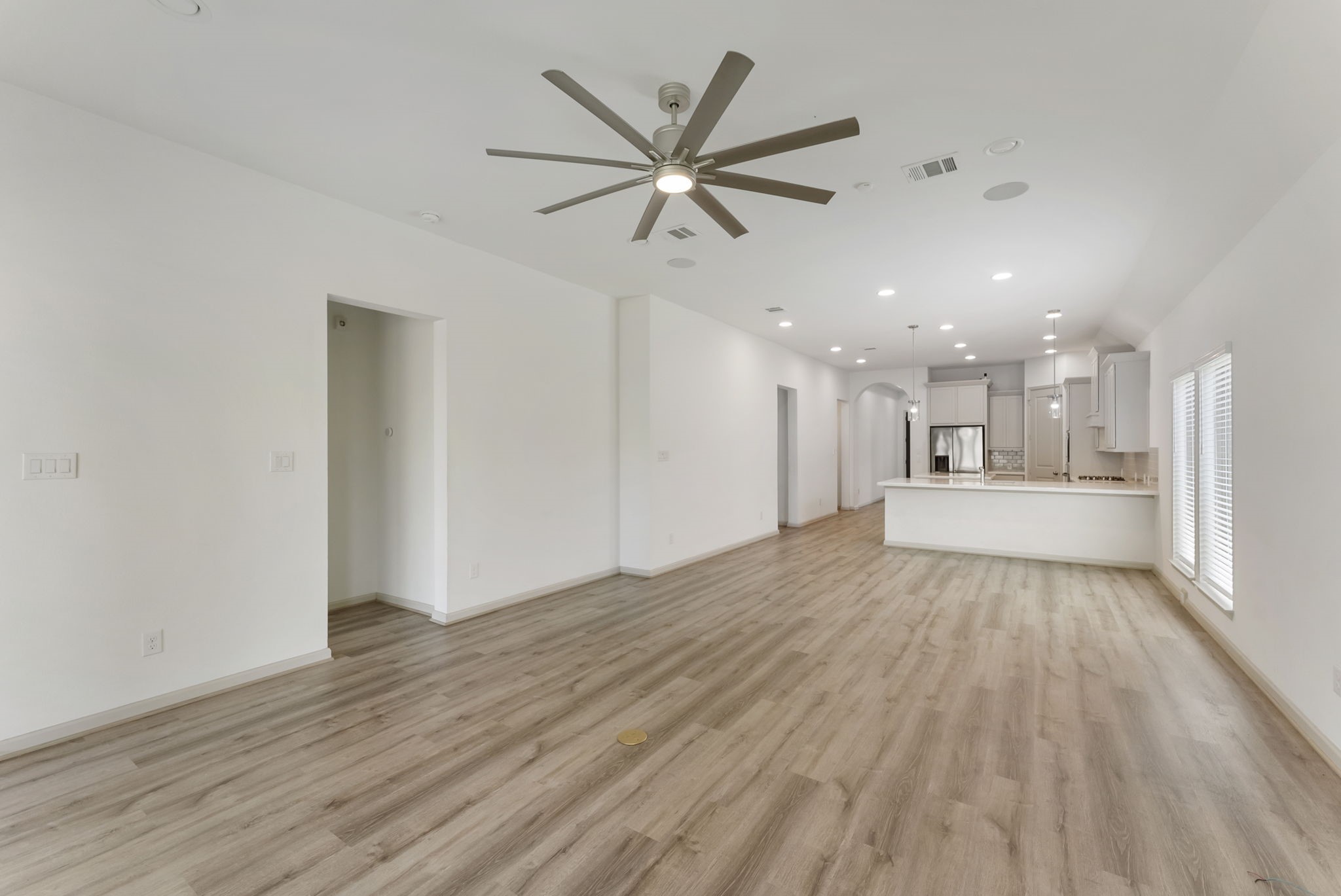 17192 Wild Robin Lane Conroe, TX 77302 - Photo 7 of 15 a view of an empty room with wooden floor and a ceiling fan