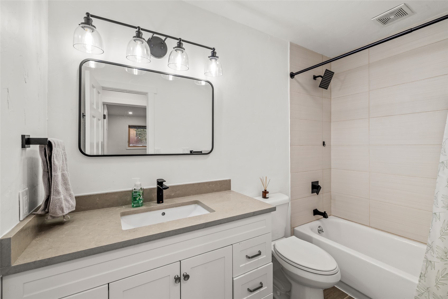 1375 Walton Creek Road, Unit 7 Steamboat Springs, CO 80487 - Photo 17 of 21 a bathroom with a granite countertop sink a toilet and a mirror