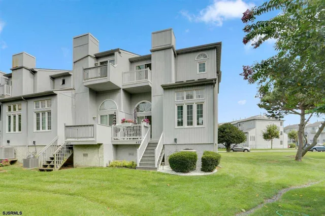 a view of a house with a yard and sitting area