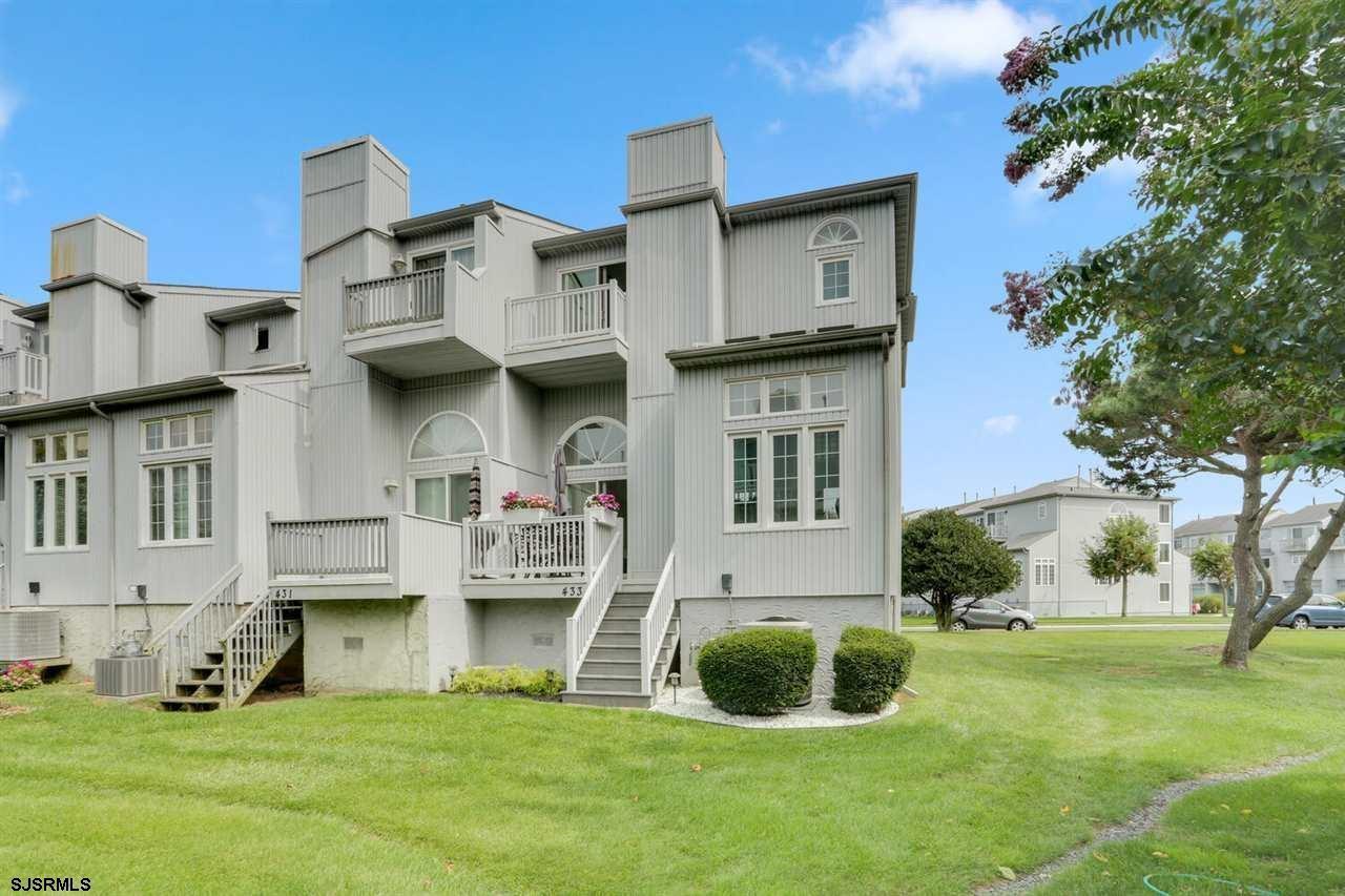 a view of a house with a yard and sitting area