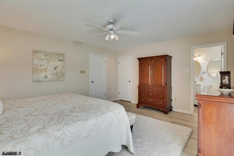 433 Albacore Lane Brigantine, NJ 08203 - Photo 18 of 22 a bedroom with a bed and a chandelier