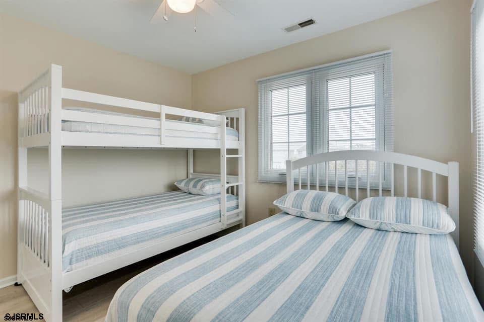433 Albacore Lane Brigantine, NJ 08203 - Photo 20 of 22 a bedroom with a bed and a night stand