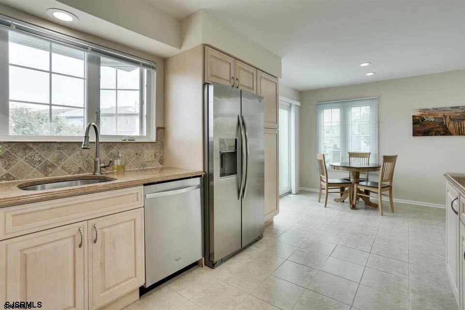 433 Albacore Lane Brigantine, NJ 08203 - Photo 10 of 22 a kitchen with stainless steel appliances granite countertop a sink and a refrigerator