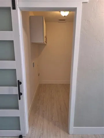 a view of a small space with wooden floor and closet