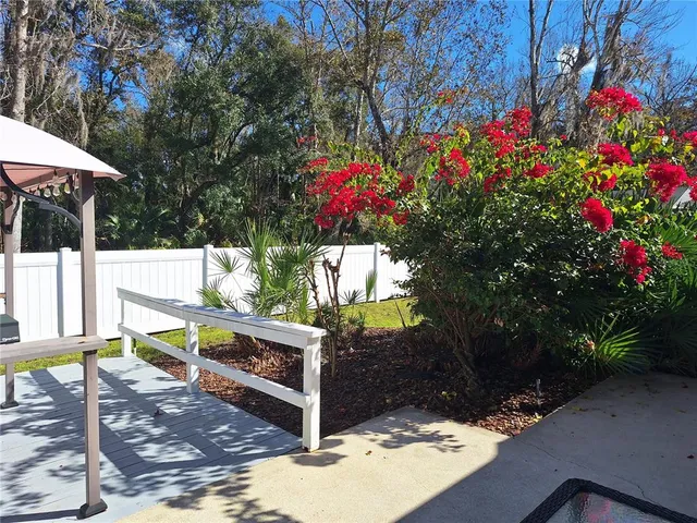 a view of a bench in the patio next to a yard