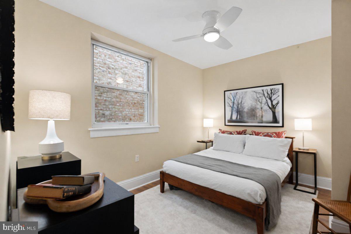 1625 16th Street Northwest, Unit 302 Washington, DC 20009 - Photo 13 of 26 a bedroom with a bed and a painting on the wall
