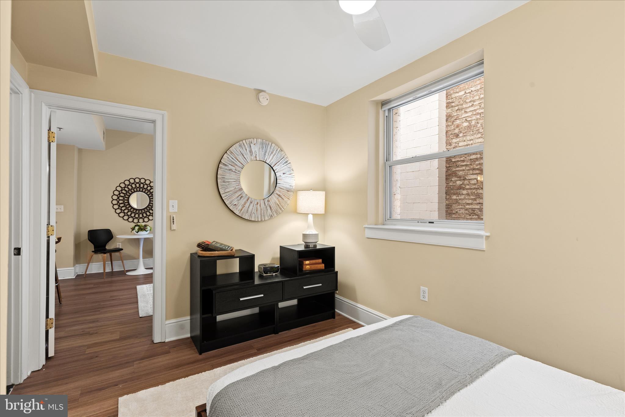 1625 16th Street Northwest, Unit 302 Washington, DC 20009 - Photo 14 of 26 a living room with furniture a window and a clock