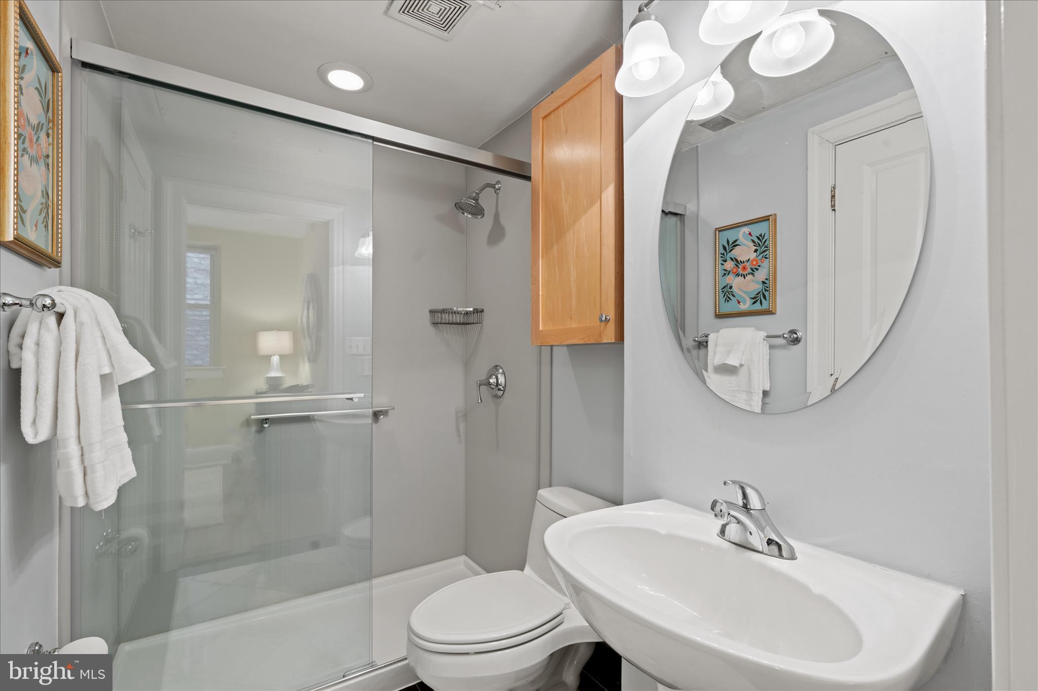 1625 16th Street Northwest, Unit 302 Washington, DC 20009 - Photo 16 of 26 a bathroom with a toilet a sink and a mirror