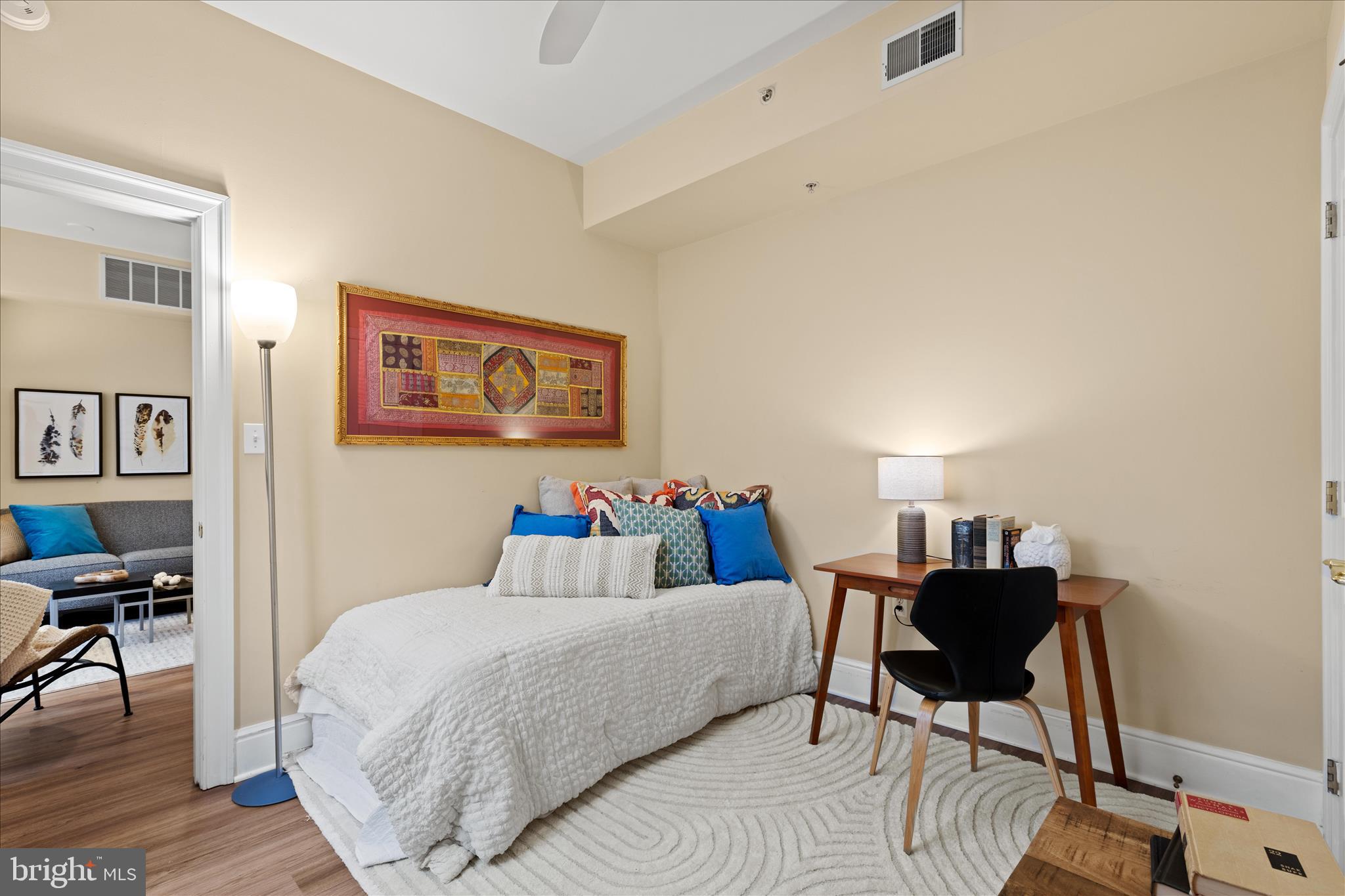 1625 16th Street Northwest, Unit 302 Washington, DC 20009 - Photo 17 of 26 a bedroom with a bed and a table in it