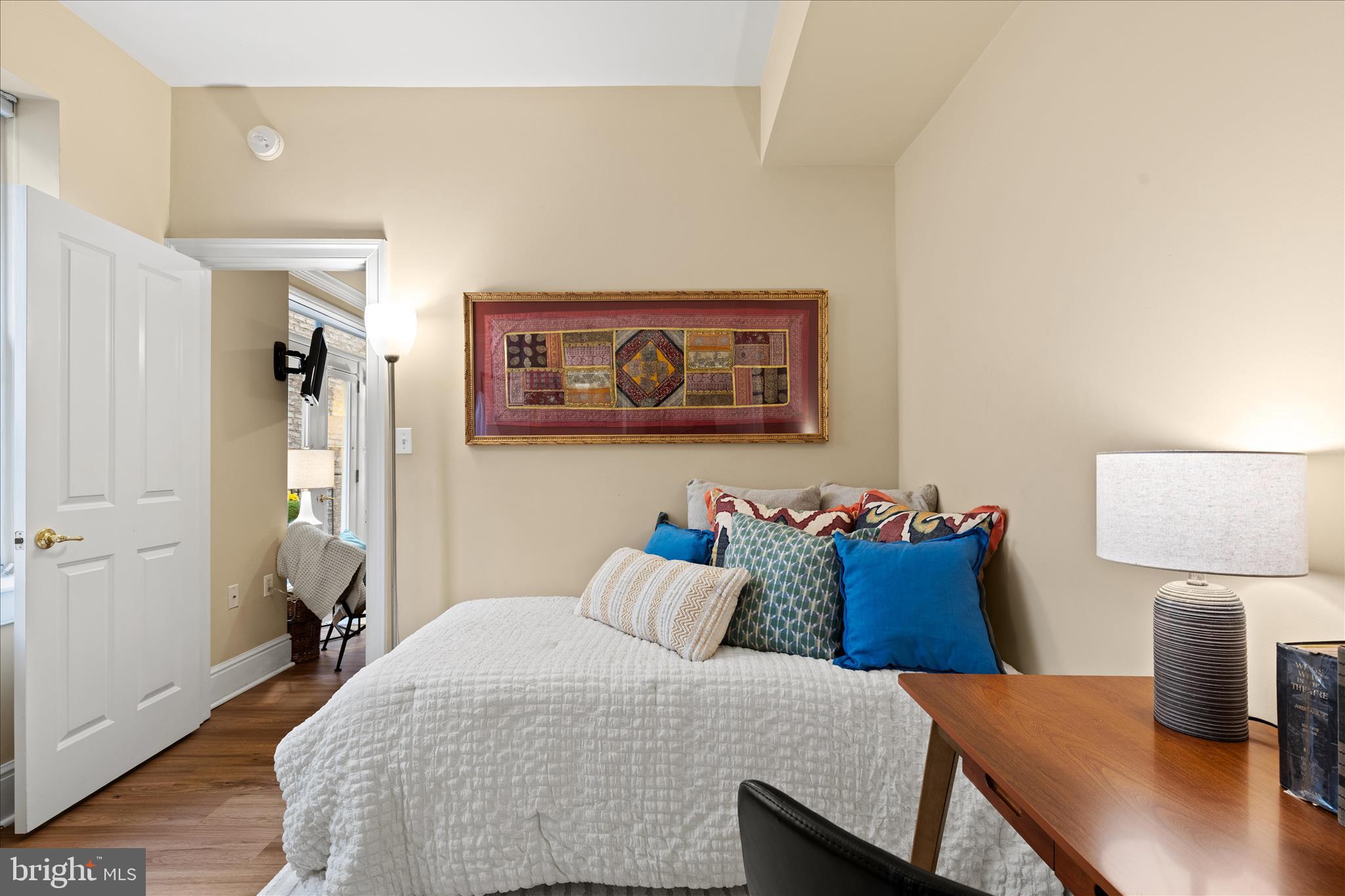 1625 16th Street Northwest, Unit 302 Washington, DC 20009 - Photo 19 of 26 a bedroom with a bed and wooden floor