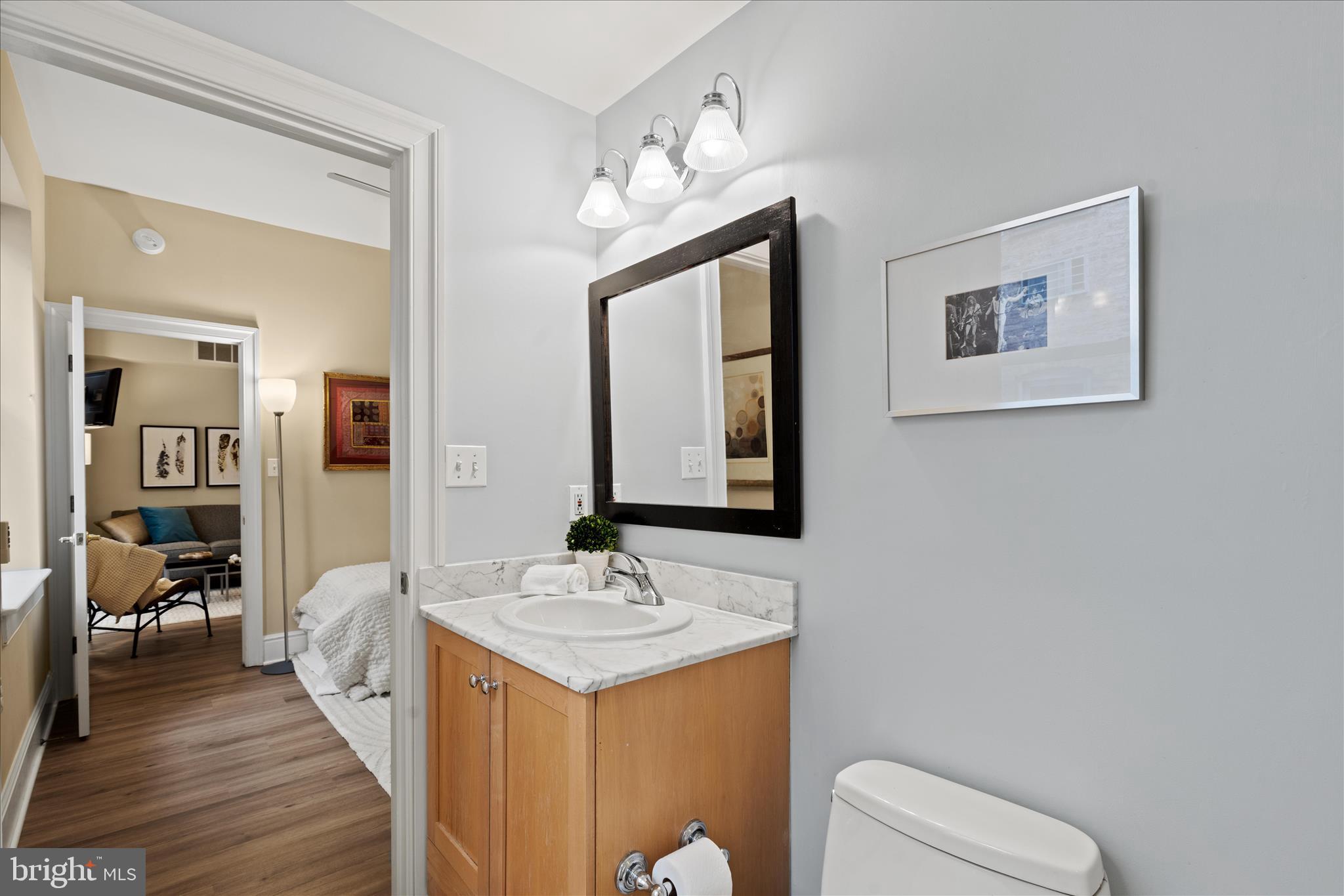 1625 16th Street Northwest, Unit 302 Washington, DC 20009 - Photo 21 of 26 a en suite bathroom with a double vanity sink and a mirror