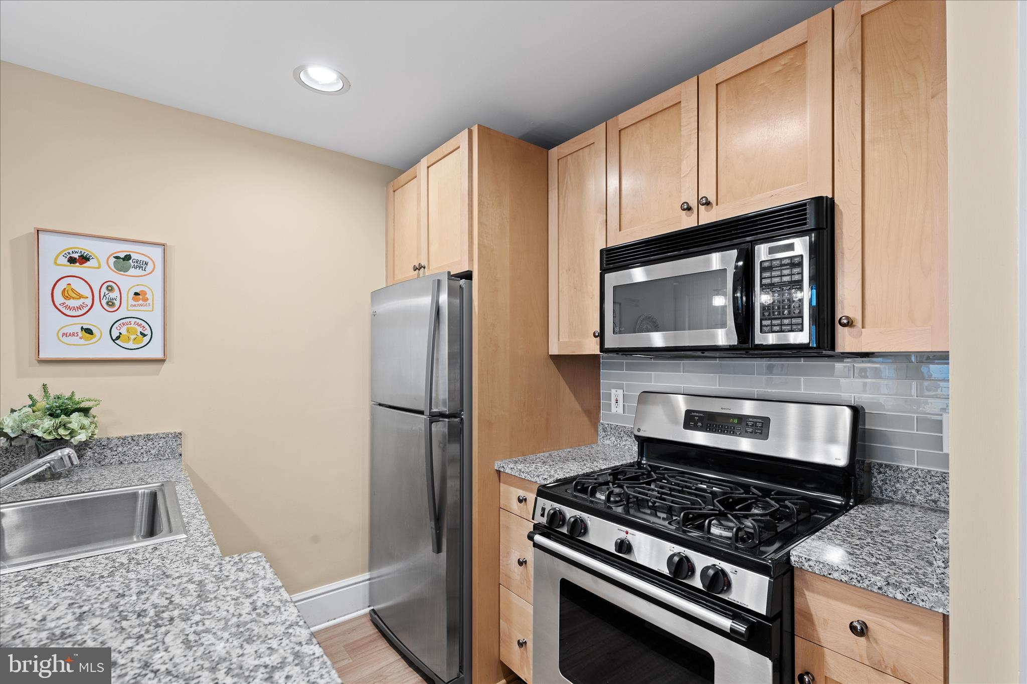 1625 16th Street Northwest, Unit 302 Washington, DC 20009 - Photo 6 of 26 a kitchen with a stove and a microwave
