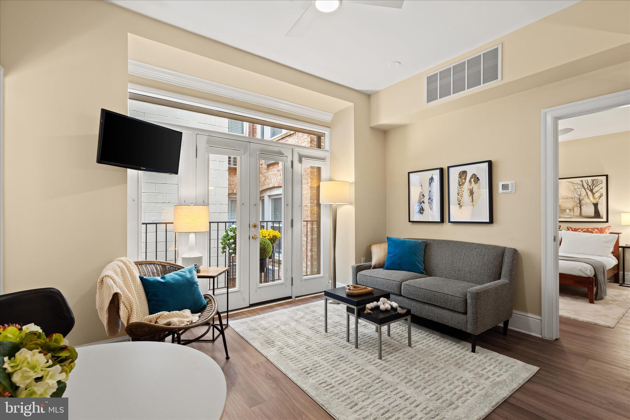 1625 16th Street Northwest, Unit 302 Washington, DC 20009 - Photo 10 of 26 a living room with furniture and a flat screen tv