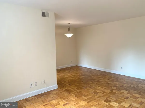 a view of a hallway with a chandelier fan