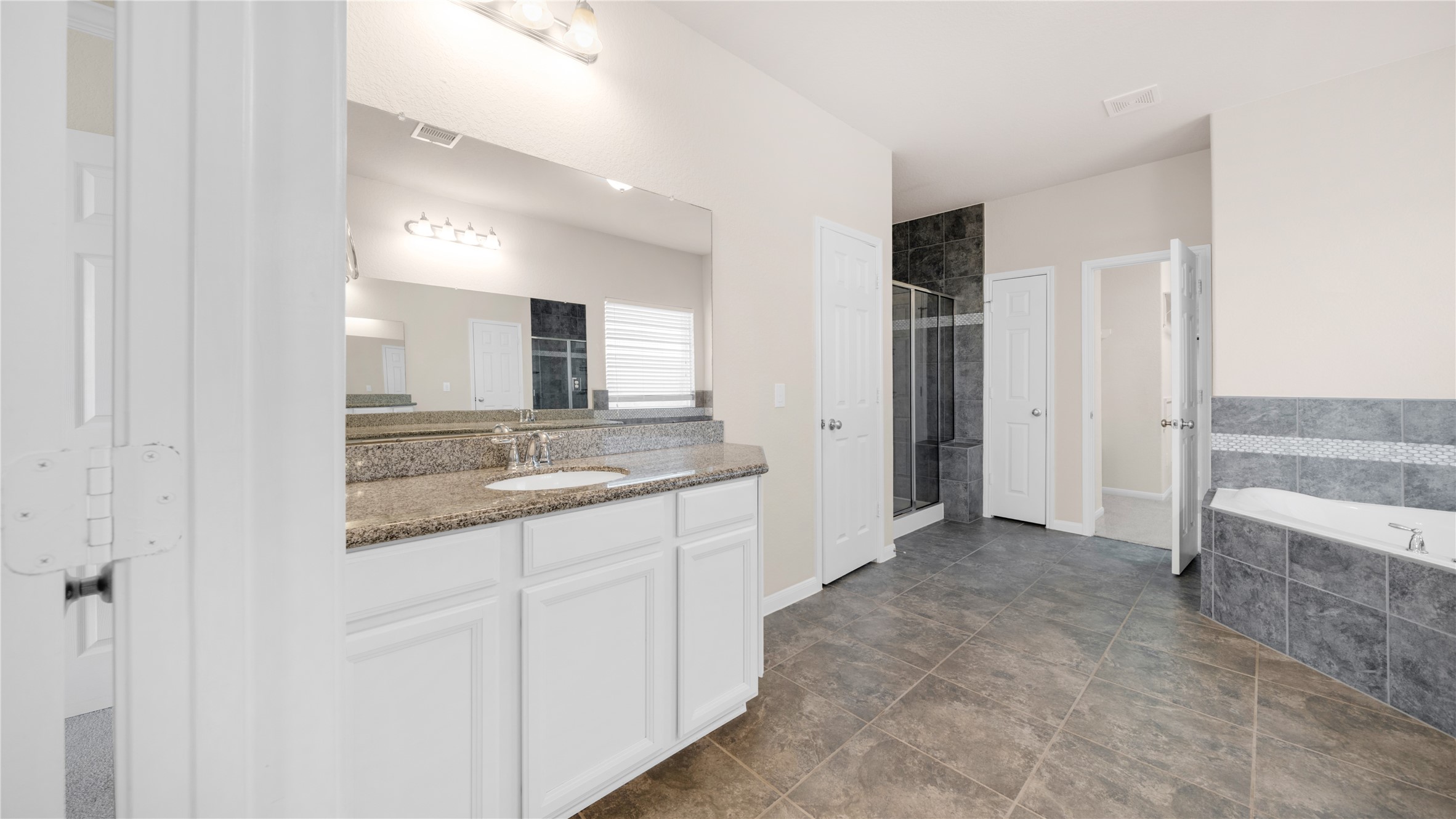 4603 Clearwater Road Baytown, TX 77523 - Photo 15 of 31 a bathroom with a granite countertop sink and a mirror