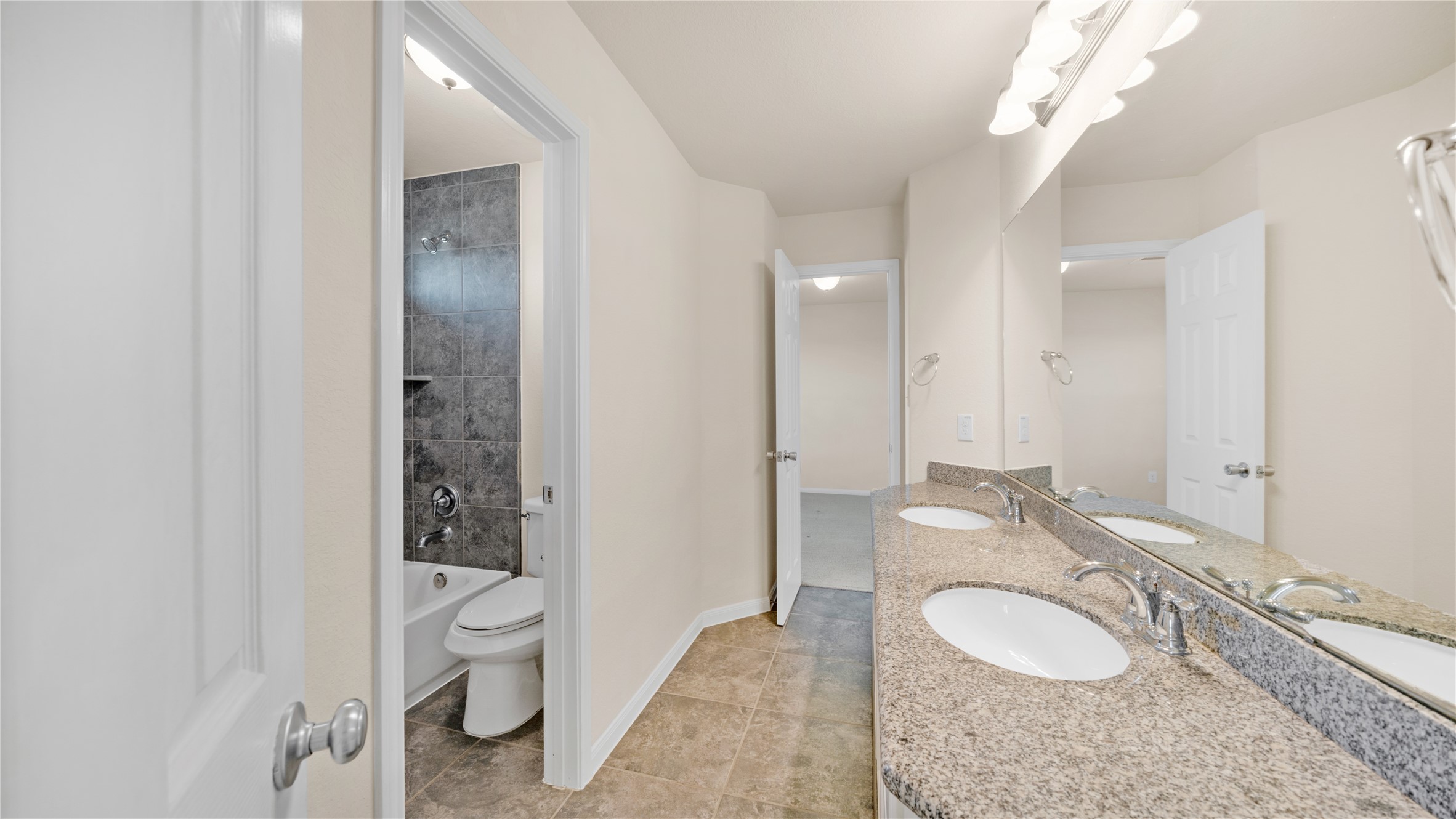 4603 Clearwater Road Baytown, TX 77523 - Photo 23 of 31 a bathroom with a granite countertop double vanity sink mirror and toilet