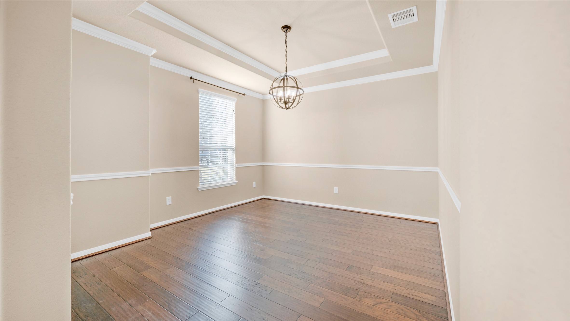 4603 Clearwater Road Baytown, TX 77523 - Photo 7 of 31 an empty room with wooden floor ceiling fan and windows