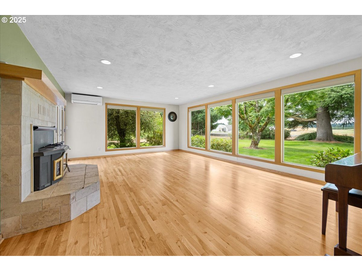 11623 Broadacres Road Northeast Hubbard, OR 97032 - Photo 15 of 48 a view of an empty room with wooden floor and a window