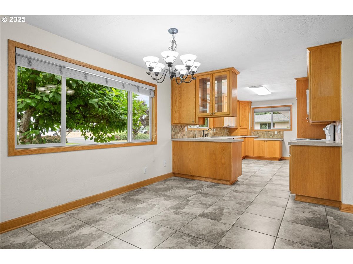 11623 Broadacres Road Northeast Hubbard, OR 97032 - Photo 5 of 48 a view of a kitchen with granite countertop natural light