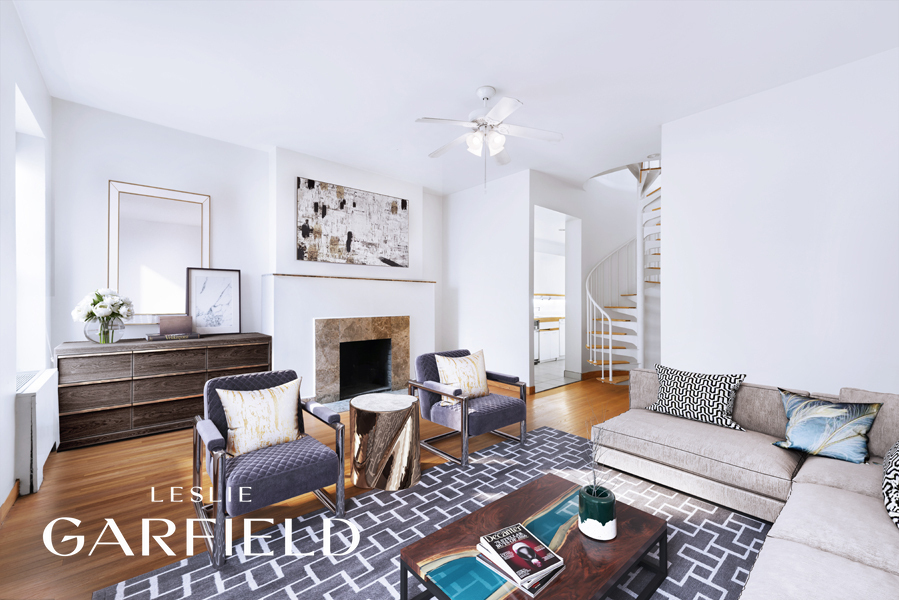 23 West 69th Street Manhattan, NY 10023 - Photo 7 of 10 a living room with furniture a rug and a fireplace