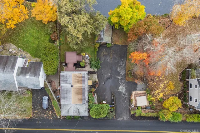 an aerial view of a house with yard and garage