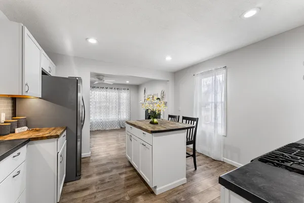 a kitchen with stainless steel appliances granite countertop a stove and a refrigerator