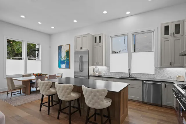 a large white kitchen with a large window