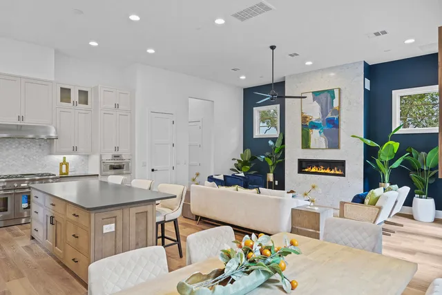 a kitchen with stainless steel appliances granite countertop a sink stove and cabinets