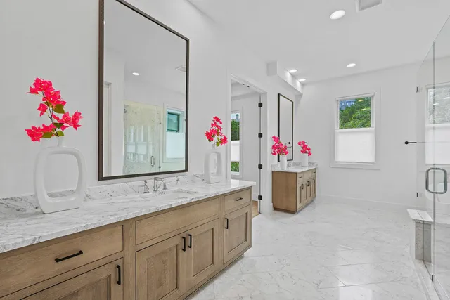 a bathroom with a sink mirror and vanity