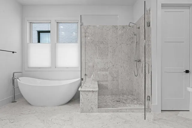 a bathroom with a bathtub and shower