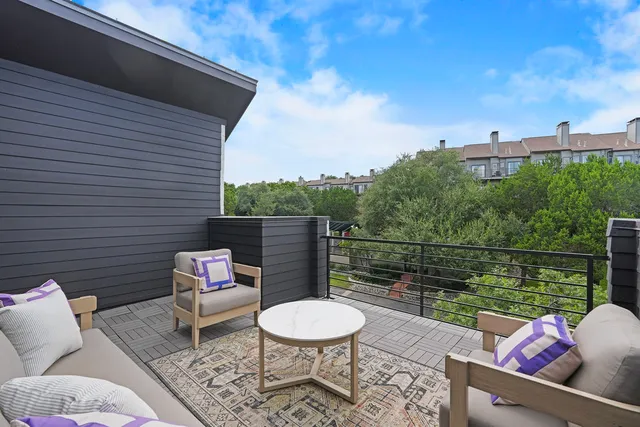 a backyard of a house with outdoor seating