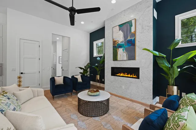 a living room with furniture and a potted plant