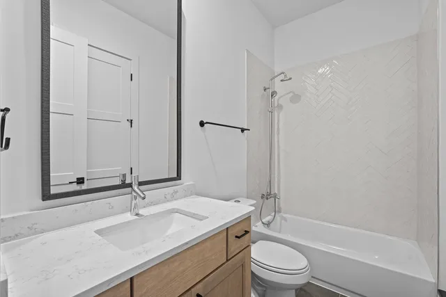 a bathroom with a sink toilet tub and shower