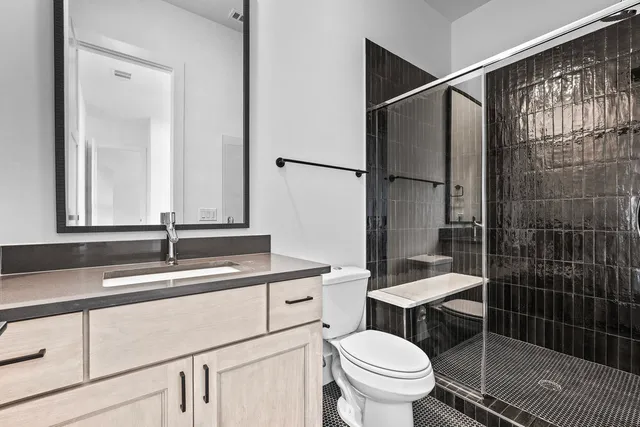 a bathroom with a sink toilet and shower