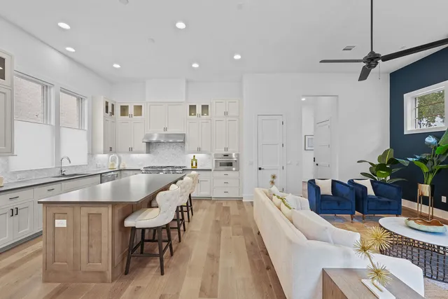 a living room with furniture a rug and a window