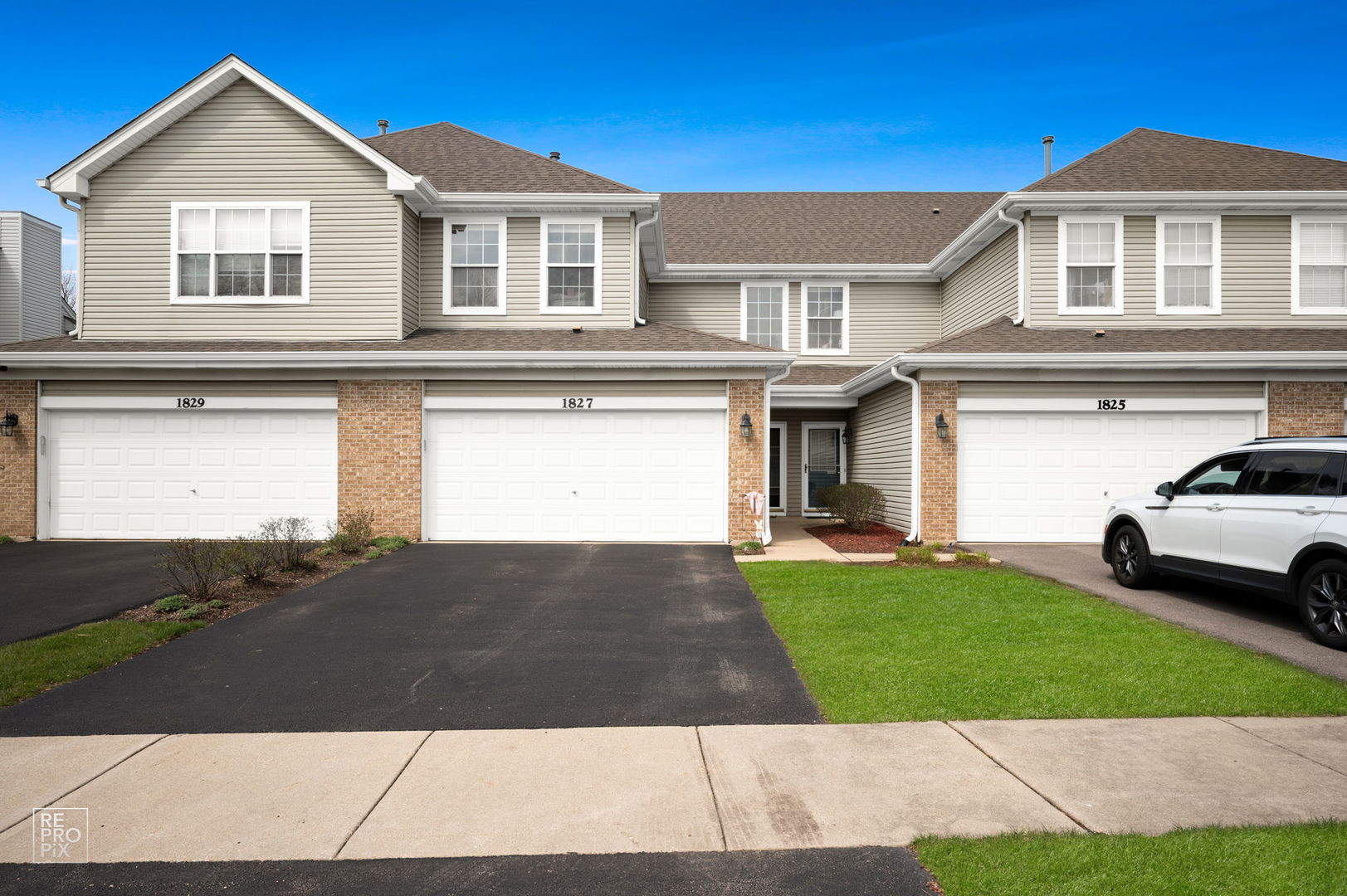 1827 Golden Gate Lane Naperville, IL 60563 - Photo 1 of 13 a front view of a house with a yard and garage