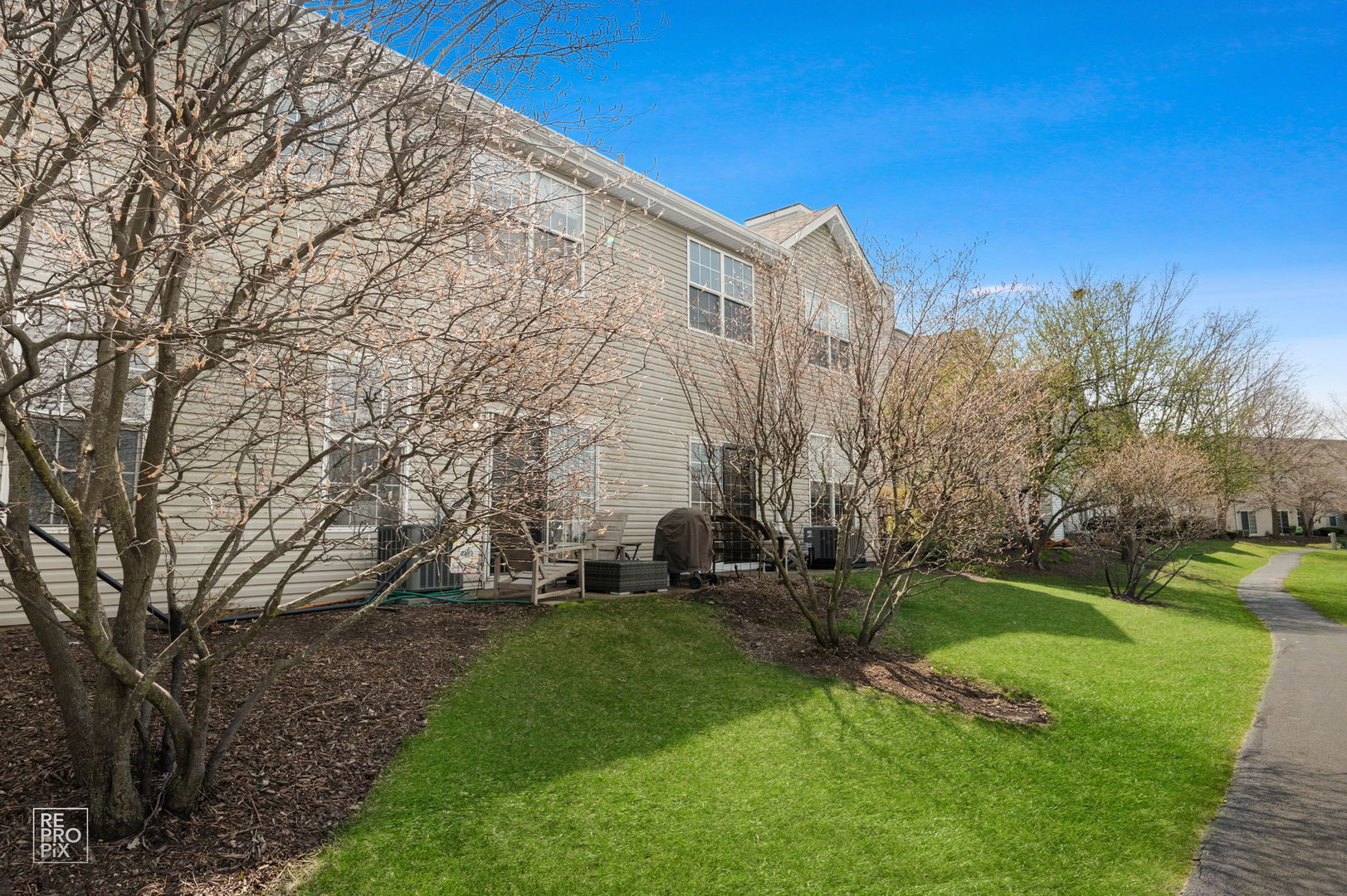 1827 Golden Gate Lane Naperville, IL 60563 - Photo 12 of 13 a backyard of a house with lots of green space and outdoor seating