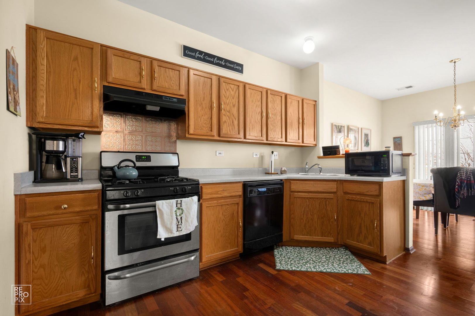 1827 Golden Gate Lane Naperville, IL 60563 - Photo 3 of 13 a kitchen with granite countertop wooden floors and stainless steel appliances