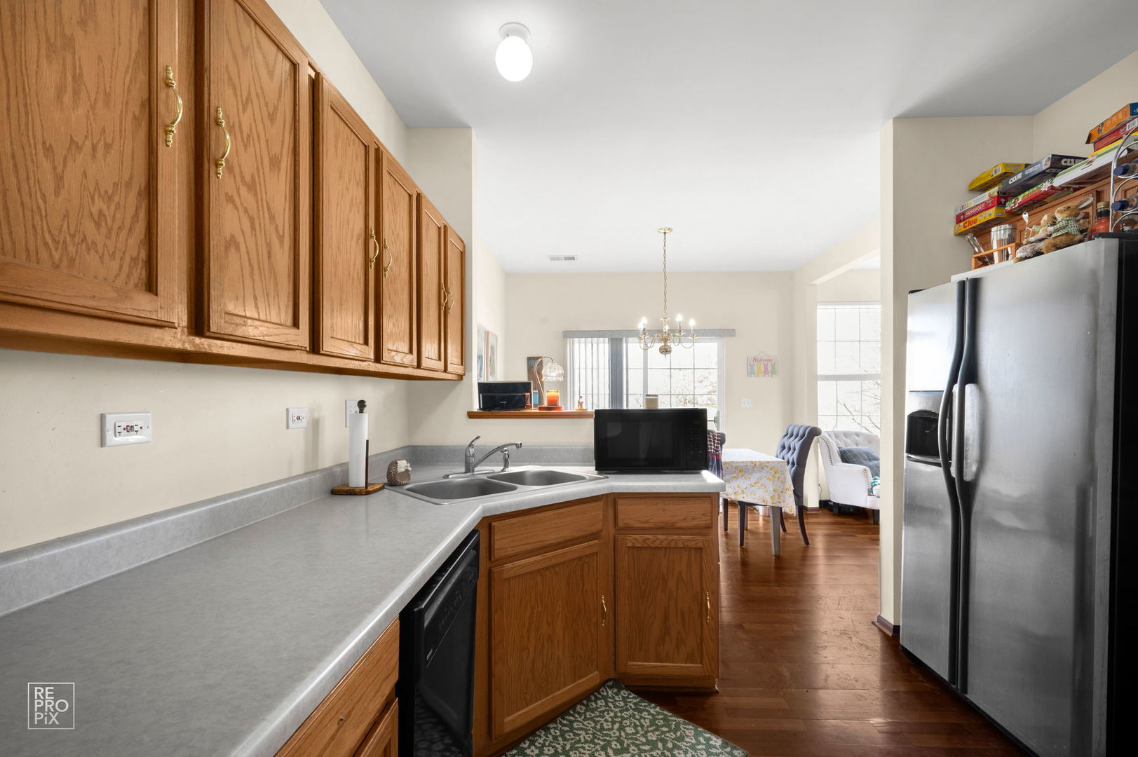 1827 Golden Gate Lane Naperville, IL 60563 - Photo 4 of 13 a kitchen with stainless steel appliances granite countertop a refrigerator sink and cabinets