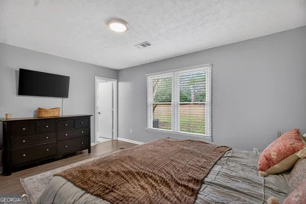 a bed room with a bed and a television