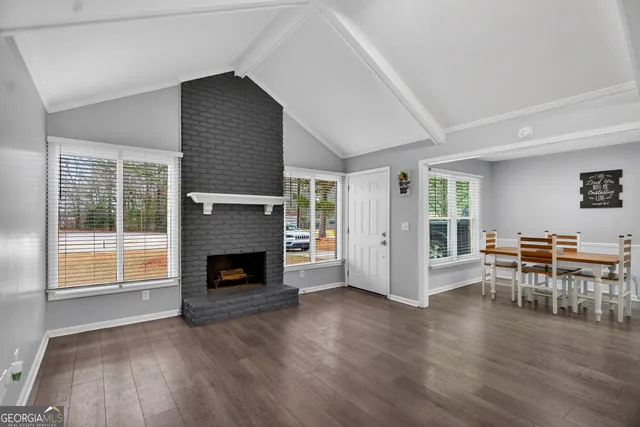 a view of a livingroom with furniture and a fireplace