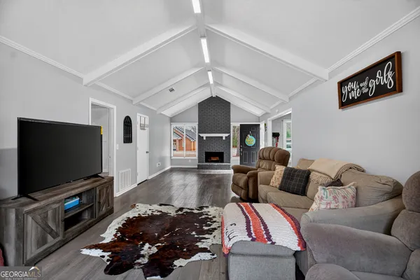 a living room with furniture and a flat screen tv