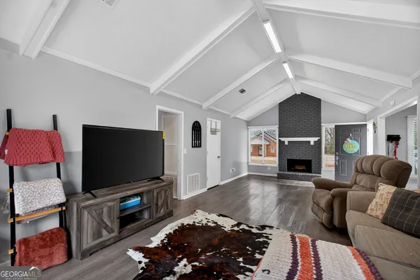 a living room with furniture and a flat screen tv