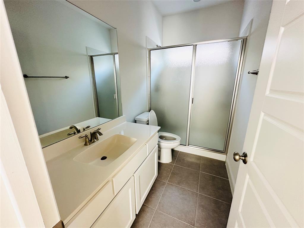 806 Davids Way Allen, TX 75013 - Photo 24 of 24 a bathroom with a sink mirror toilet and shower