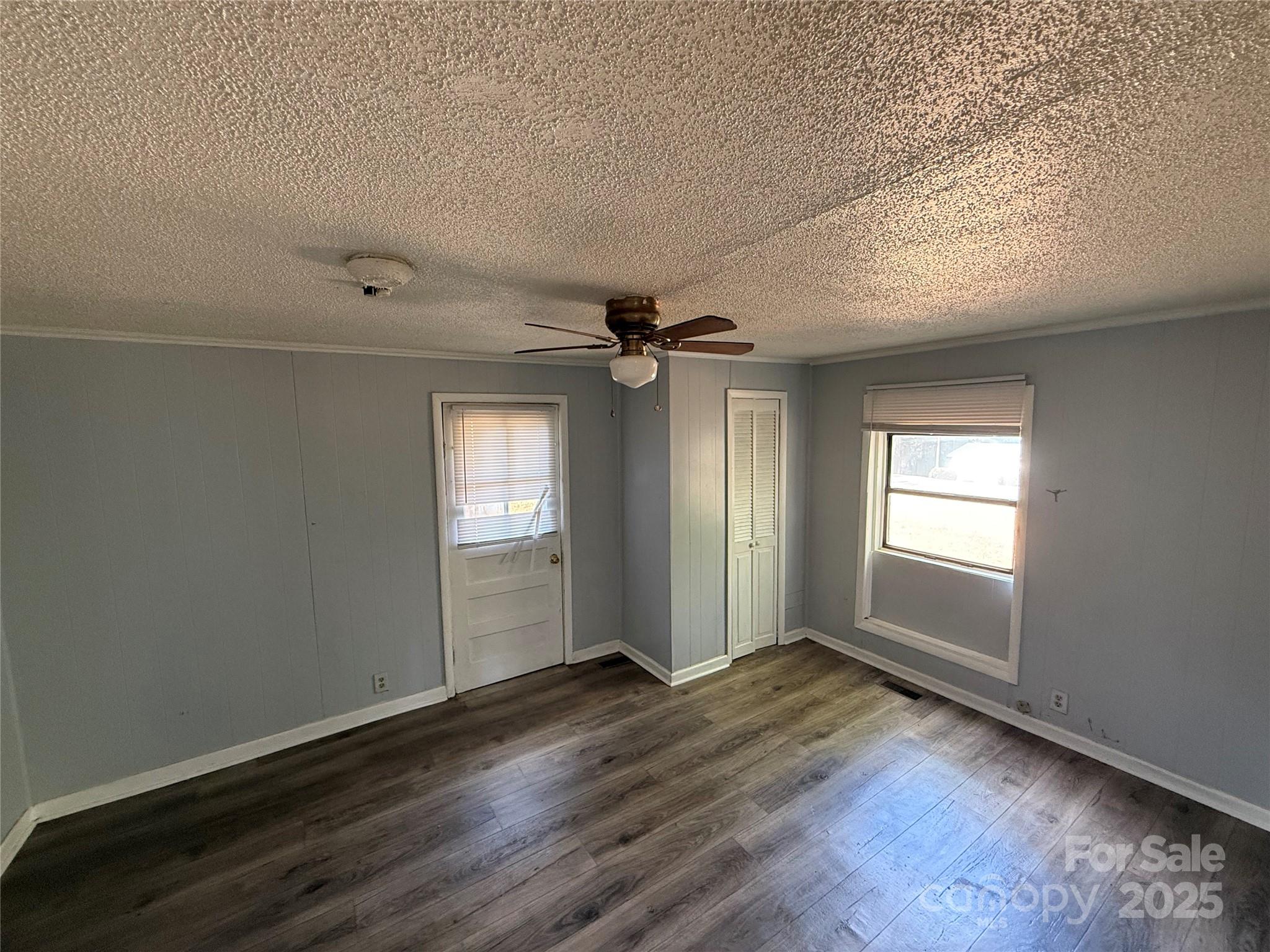 175 Rush Loop Road Mount Gilead, NC 27306 - Photo 6 of 10 wooden floor in an empty room with a window