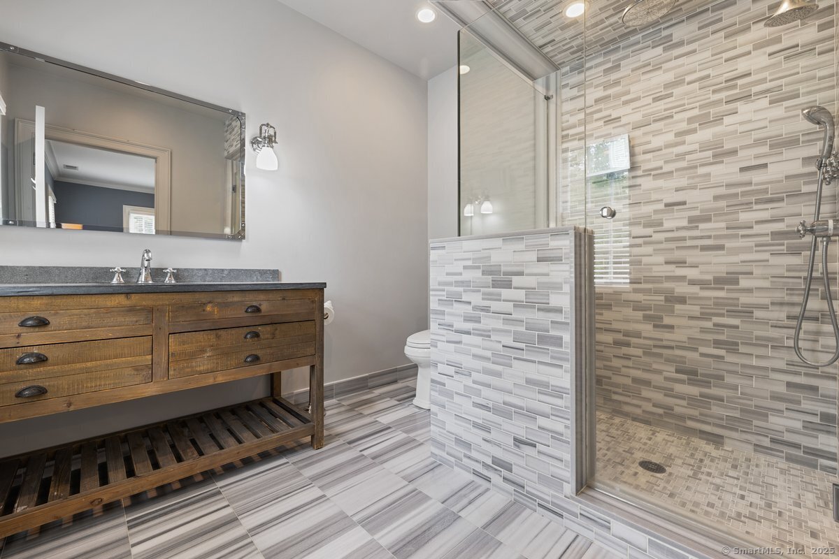 174 Branchville Road Ridgefield, CT 06877 - Photo 24 of 40 a bathroom with a sink a mirror and shower